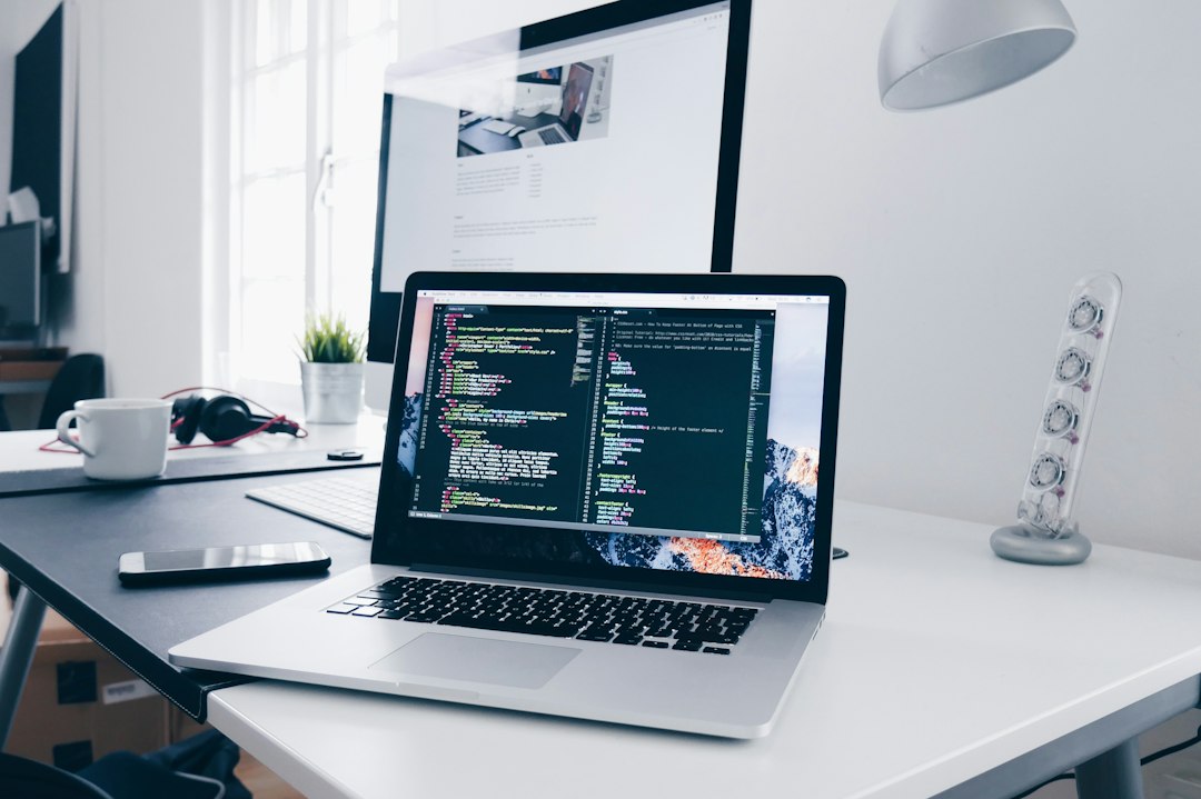Laptop and development workspace representing Oracle APEX application hosting migration planning